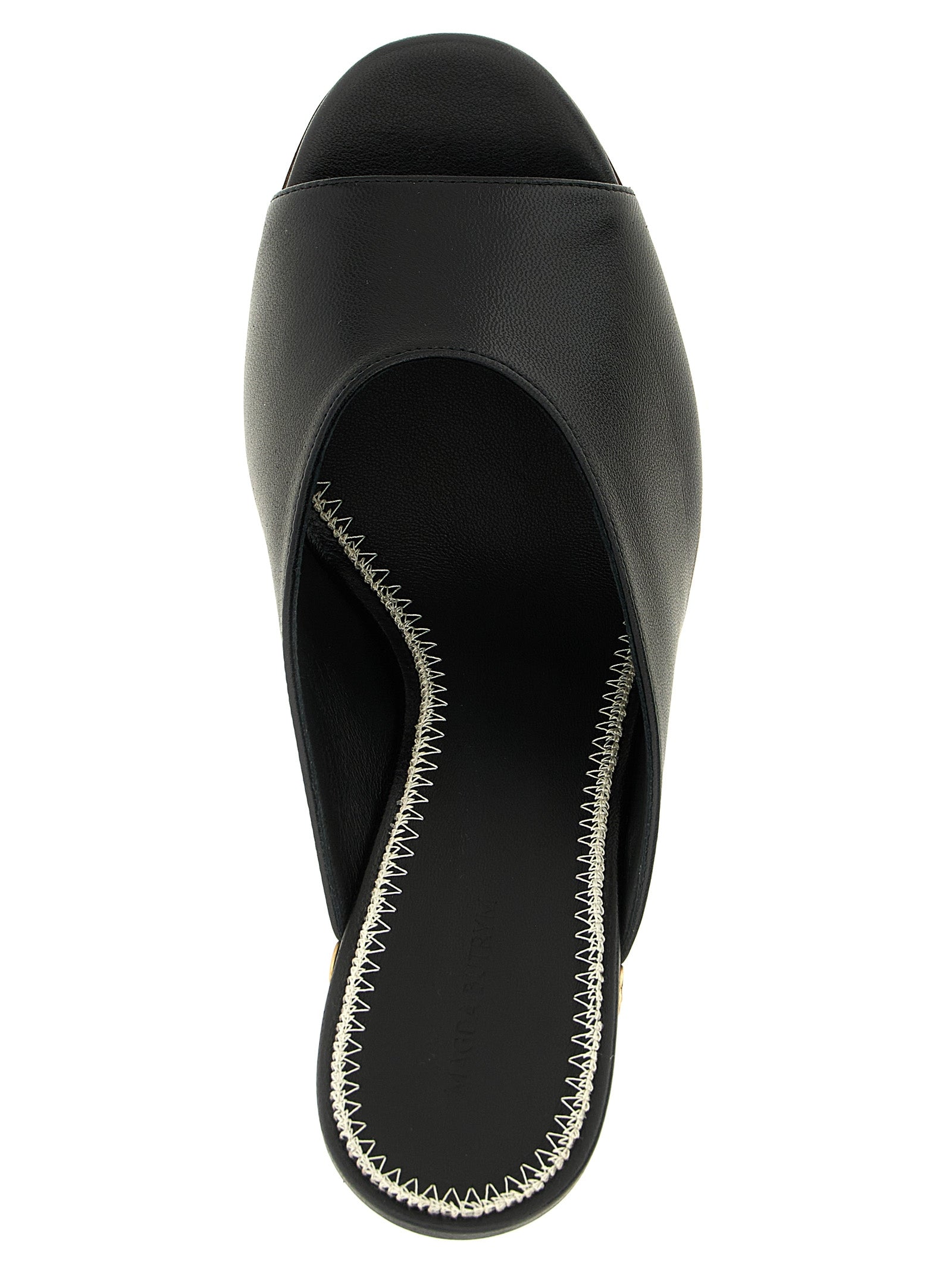 Wedge Mules Sandals by Magda Butrym for women in calfskin leather black showcases a sculptural silhouette as Women's Calfskin Leather Wedge Mules Sandals, defined by a sculptural wedge and sculptural open toe style for a sculptural look.