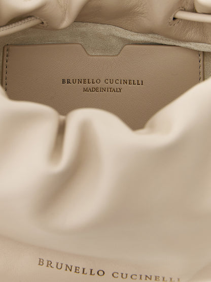 Mini Crossbody Bucket Handbag by Brunello Cucinelli for women in lamb leather gold, white & signature features a multifaceted silhouette, showcasing a secure drawstring and multifaceted with versatile crossbody-strap & shoulder-strap for multifaceted style.