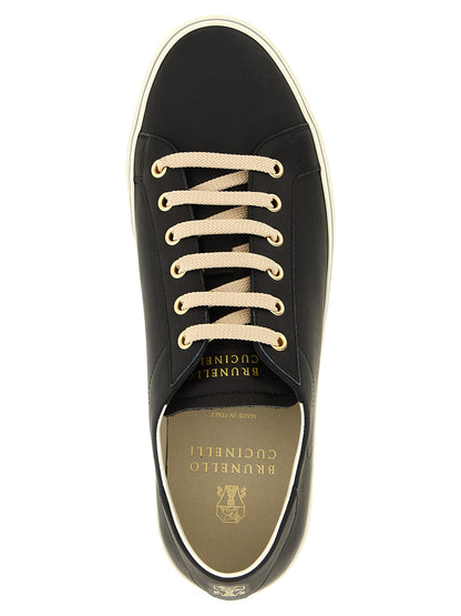 Sneakers by Brunello Cucinelli for men in calfskin leather black, gold & striped features an versatile design from the Men's Low Top Calfskin Leather Sneakers collection, highlighting a versatile low-top style for a premium, high-fashion look.