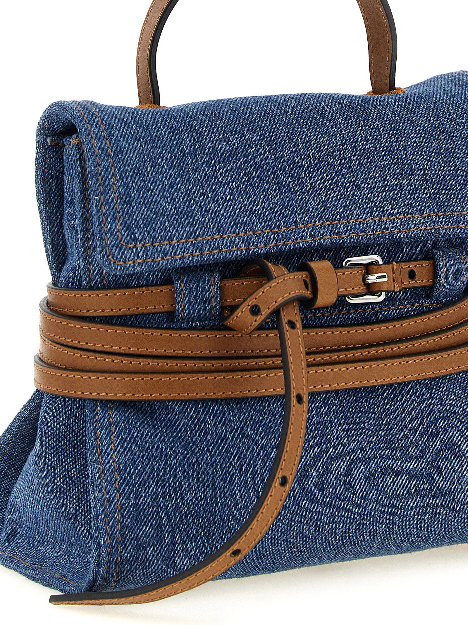 This Small Handbag by Moschino for women in calf leather & cotton and blue & brown presents a sculptural silhouette featuring a secure , ample , and versatile shoulder-strap, handle & adjustable-strap for a sculptural finish.