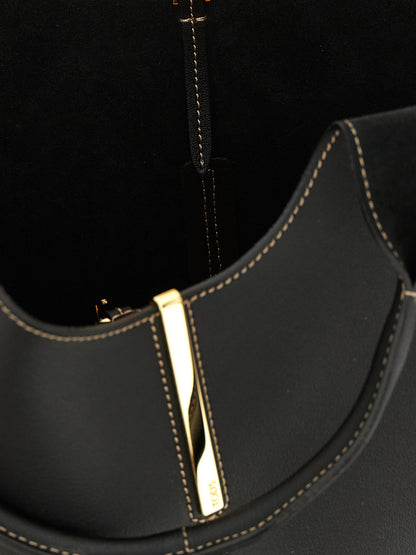 Small Tote Bag by Tod's for women in calfskin leather black & gold features an sumptuous Calfskin Leather Small Tote Bag design with a secure hook, ample , and versatile shoulder-strap, handle & detachable-strap for an sumptuous finish.