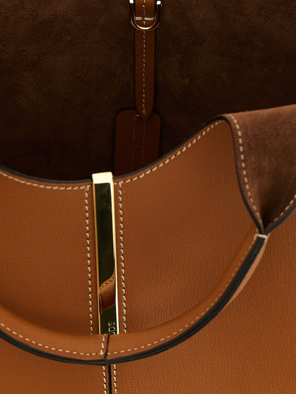 Mni Tote Bag by Tod's for women in calfskin leather brown & gold features an jet-setting Calfskin Leather Mni Tote Bag design with a secure , jet-setting , and versatile shoulder-strap & handle for a jet-setting look.