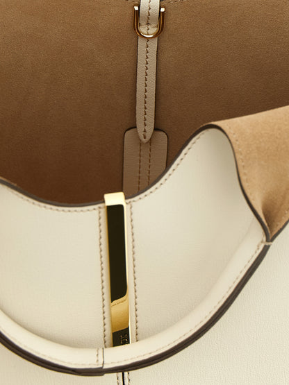 Mni Tote Bag by Tod's for women in suede calfskin leather cream, gold & white showcases a urban-chic Suede Calfskin Leather Mni Tote Bag design, featuring a secure hook, ample , and versatile shoulder-strap, handle & adjustable-strap for a urban-chic finish.
