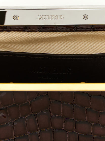 Evening Frame Clutch Handbag by Jacquemus for women in faux crocodile skin leather brown, gold & silver showcases a sculptural silhouette, featuring a secure , ample , and versatile handle for a sculptural finish.