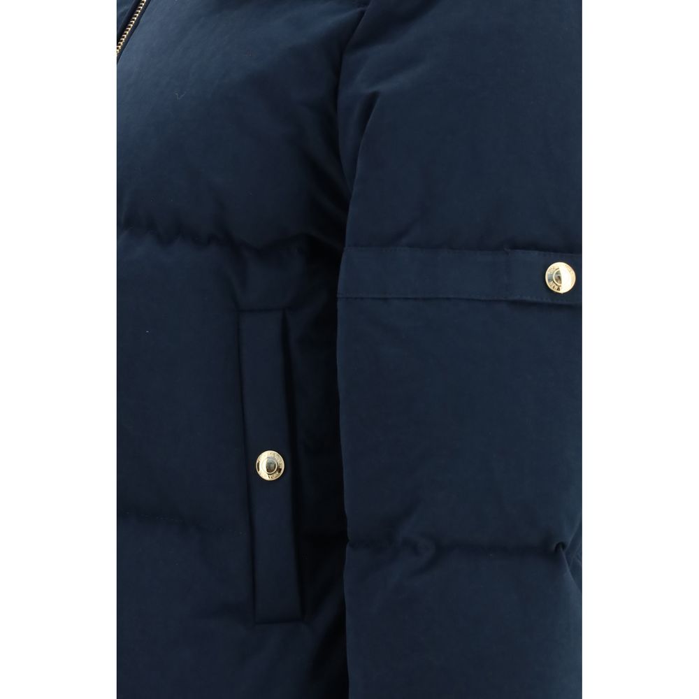 This Hooded Puffer Jacket by Thom Browne for women in cotton polyester blue & gold exhibits a edgy silhouette, meticulously detailed with functional pockets, hooded & insulated and a edgy for a edgy finish.