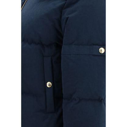 This Hooded Puffer Jacket by Thom Browne for women in cotton polyester blue & gold exhibits a edgy silhouette, meticulously detailed with functional pockets, hooded & insulated and a edgy for a edgy finish.