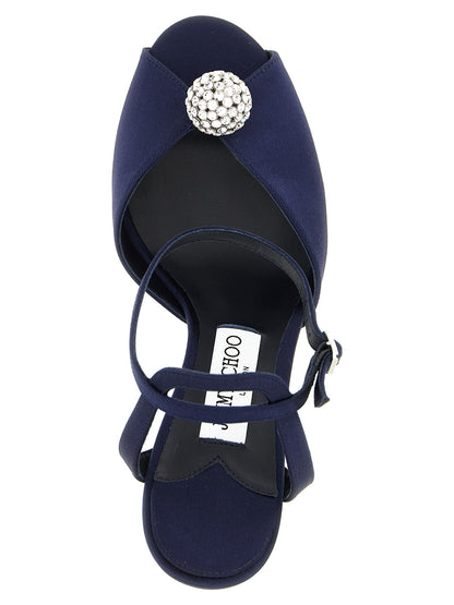 Stiletto Ankle Strap Sandals by Jimmy Choo for women in leather satin & crystal navy features an exquisite silhouette, showcasing the exquisite Women's Leather Satin & Crystal Stiletto Ankle Strap Sandals with a stiletto and peep toe style.