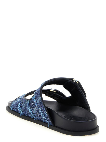 Sliders Sandals Flat Shoes by Jimmy Choo for women in denim blue, gold & pearl presents a effortless chic silhouette, showcasing the Women's Denim Sliders Sandals Flat Shoes design with a effortless chic and for a sophisticated look.