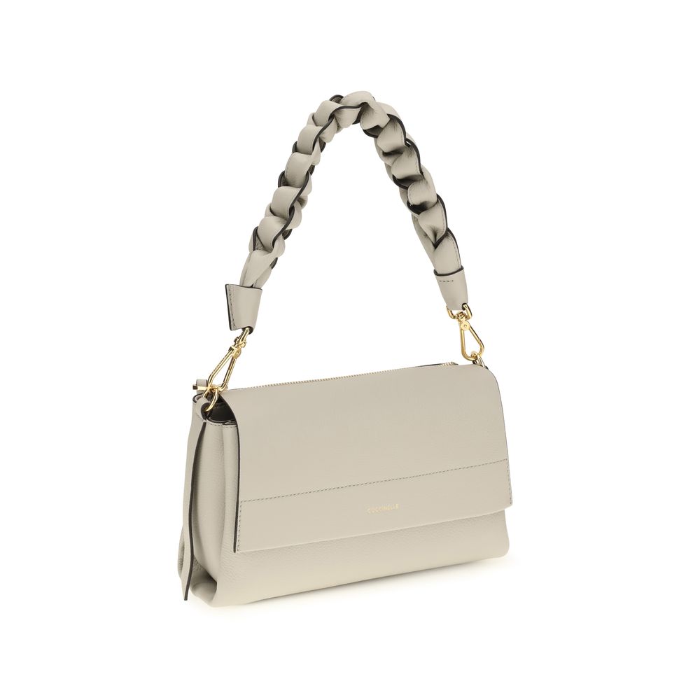 2-in-1 Shoulder & Crossbody Flap Bag by Coccinelle for women in bos taurus calf leather beige presents a versatile silhouette, showcasing a secure flap, zipper & magnetic and versatile external-pockets with versatile crossbody-strap, shoulder-strap, adjustable-strap & handle for a sophisticated look.