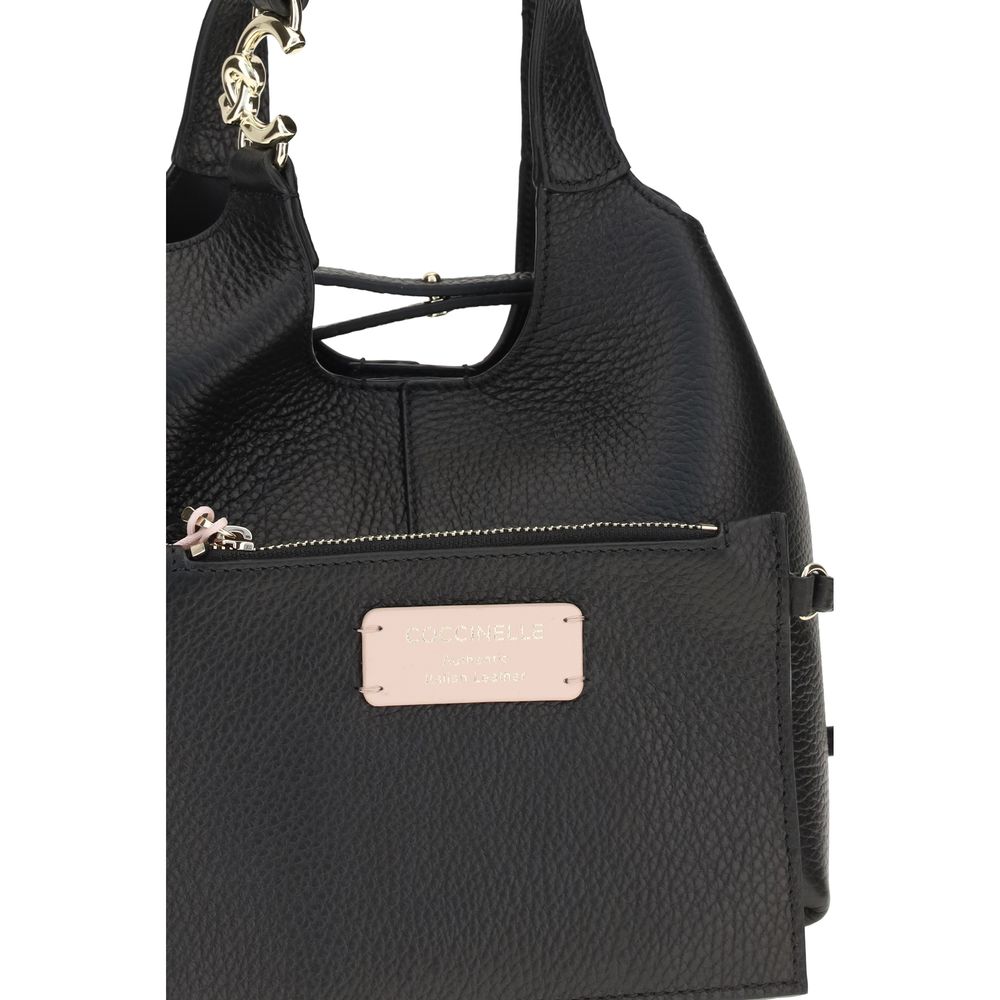 Small Crossbody Pouch Handbag by Coccinelle for women in bos taurus calf grained leather black, gold & signature features an refined silhouette, showcasing a secure zipper & button, ample , and versatile crossbody-strap, shoulder-strap, handle, adjustable-strap & detachable-strap for a sophisticated refined aesthetic.