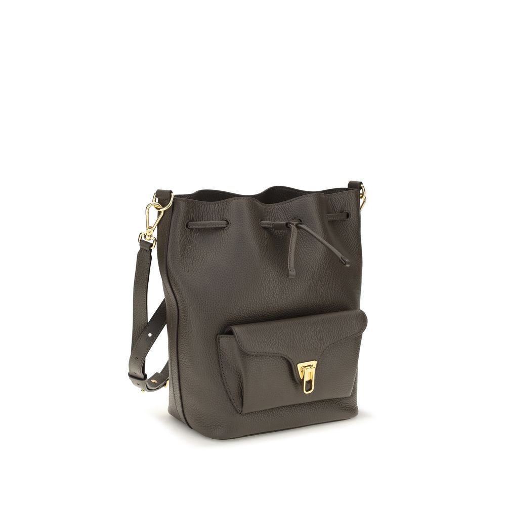Bucket Handbag by Coccinelle for women in bos taurus calf grained leather brown, gold & signature features a effortlessly chic silhouette, showcasing a secure zipper & drawstring with ample external-pockets and versatile adjustable-strap & handle for a effortlessly chic finish.