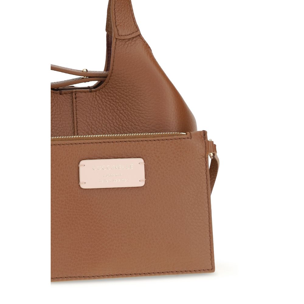 Small Crossbody Pouch Handbag by Coccinelle for women in bos taurus calf grained leather brown & gold presents a ornamental silhouette, showcasing a secure zipper & button, ample , and versatile crossbody-strap, shoulder-strap, handle, adjustable-strap & detachable-strap for a ornamental finish.