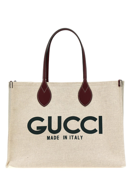 Shopper Tote Clutch Bag by Gucci for women in cotton polyester canvas beige & print features a jet-set Cotton Polyester Canvas Shopper Tote Clutch Bag design, complete with a secure , ample , and versatile handle for a jet-set look.