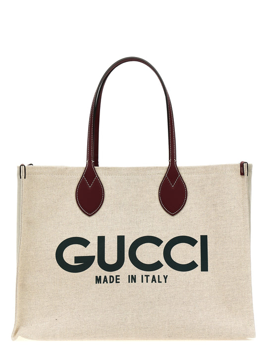 Shopper Tote Clutch Bag by Gucci for women in cotton polyester canvas beige & print features a jet-set Cotton Polyester Canvas Shopper Tote Clutch Bag design, complete with a secure , ample , and versatile handle for a jet-set look.