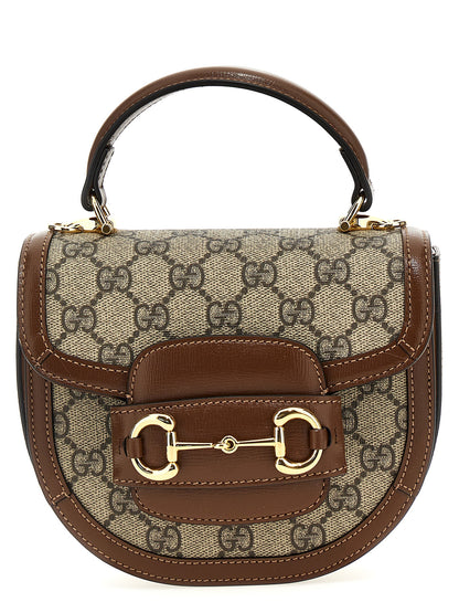 This Flap Handbag by Gucci for women in poly cotton & leather and brown & signature presents a sculptural silhouette featuring a secure flap & magnetic, ample , and versatile shoulder-strap & handle for a sculptural finish.