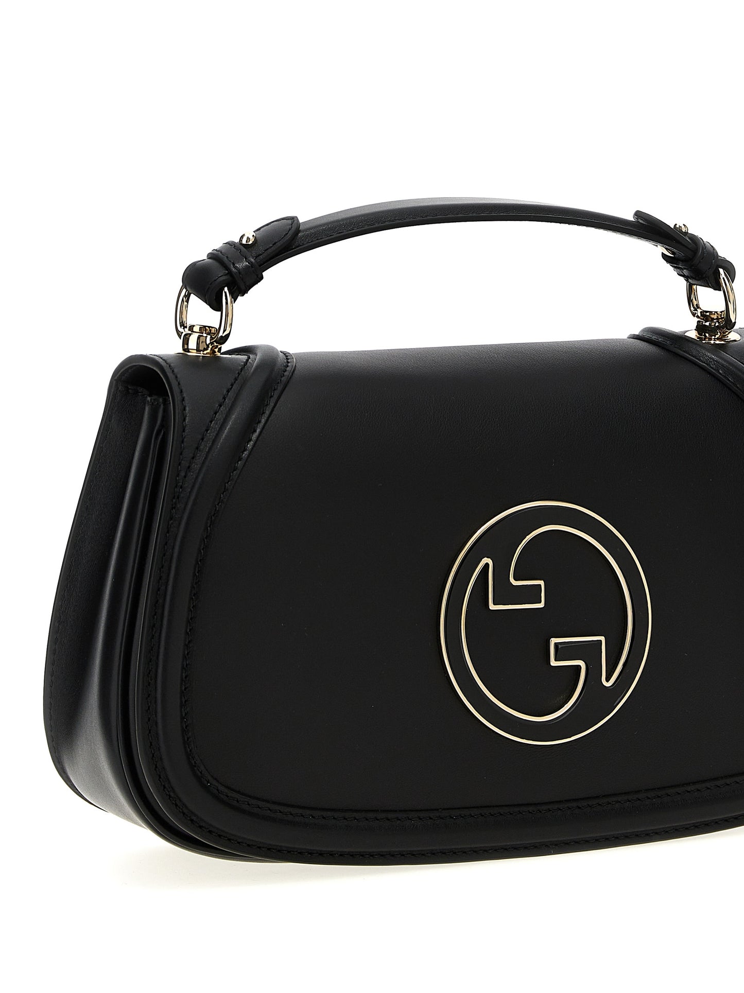 This Medium Flap Handbag by Gucci for women in calfskin leather and black presents a sculptural silhouette featuring a secure flap & magnetic, ample , and versatile shoulder-strap, handle & adjustable-strap for a sculptural finish.