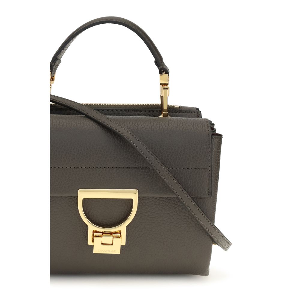 This Flap Handbag by Coccinelle for women in bos taurus calfskin leather and brown, gold, signature & monogram presents a sculptural silhouette featuring a secure flap & zipper, ample , and versatile shoulder-strap, handle & adjustable-strap for a sculptural finish.