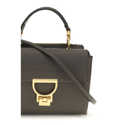 This Flap Handbag by Coccinelle for women in bos taurus calfskin leather and brown, gold, signature & monogram presents a sculptural silhouette featuring a secure flap & zipper, ample , and versatile shoulder-strap, handle & adjustable-strap for a sculptural finish.