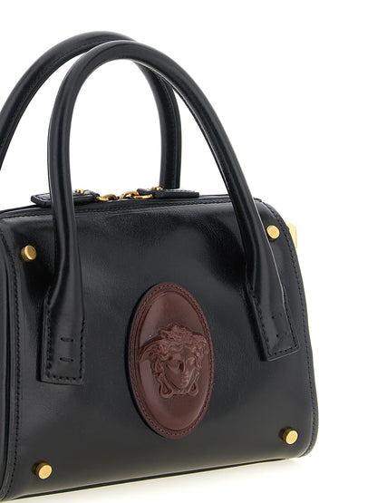 Small Handbag by Versace for women in calfskin leather black, burgundy & gold features a refined silhouette, showcasing a secure , organized , and versatile shoulder-strap, handle & detachable-strap for a refined finish.