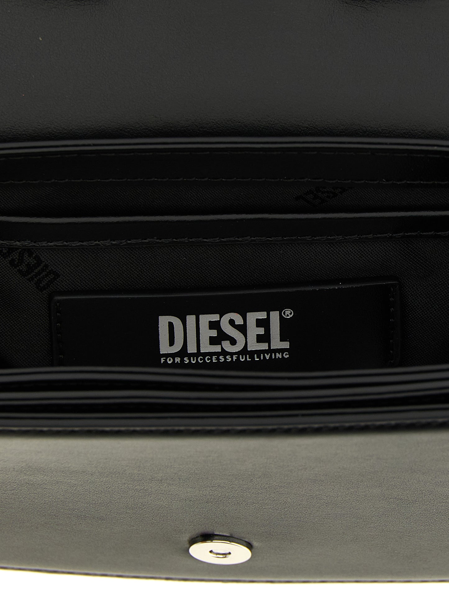 Shoulder Bag by Diesel for women in leather & metal black presents a statuesque silhouette, showcasing a secure magnetic and statuesque with versatile shoulder-strap & handle for a sophisticated look.