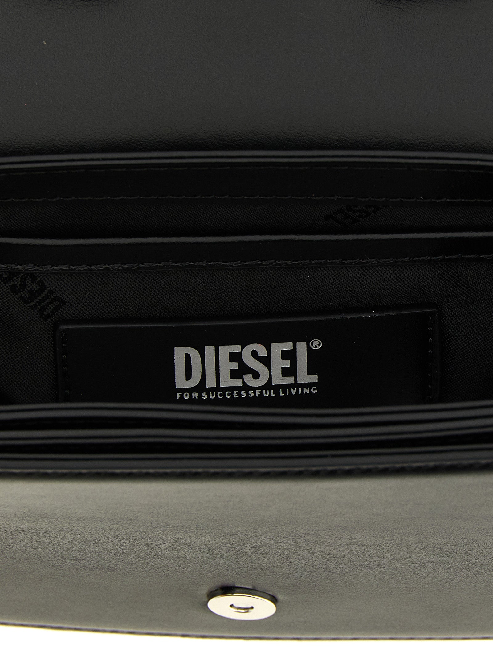 Shoulder Bag by Diesel for women in leather & metal black presents a statuesque silhouette, showcasing a secure magnetic and statuesque with versatile shoulder-strap & handle for a sophisticated look.