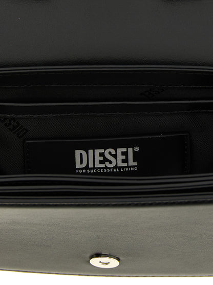 Shoulder Bag by Diesel for women in leather & metal black presents a statuesque silhouette, showcasing a secure magnetic and statuesque with versatile shoulder-strap & handle for a sophisticated look.