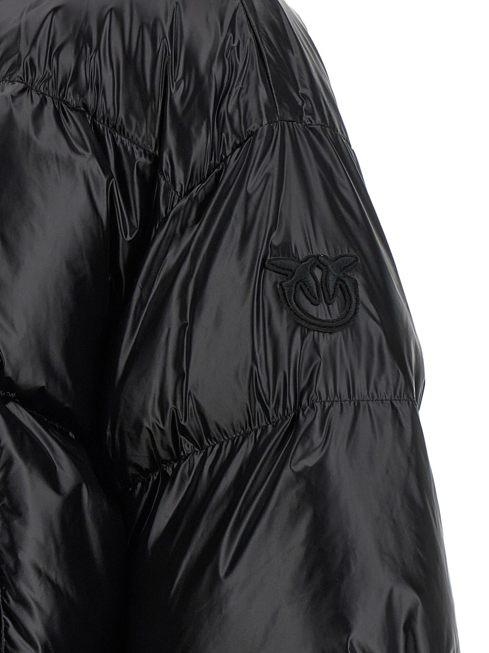 This Hooded Puffer Jacket by PINKO for women in polyamide black exhibits a edgy silhouette, meticulously detailed with functional hooded, insulated & windproof and a edgy for a edgy finish.