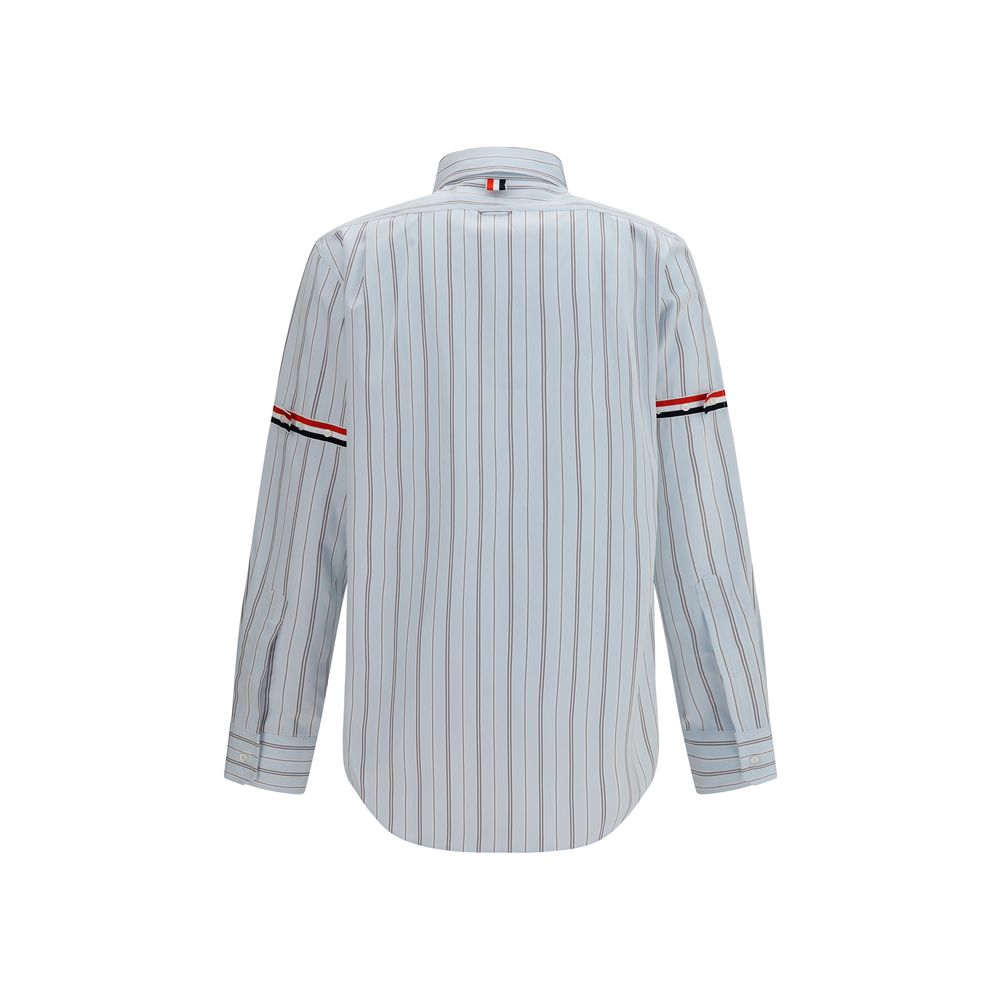 Dress Shirt by Thom Browne for men in cotton blue, signature & striped presents a discerning silhouette, showcasing a sophisticated button-down-collar neckline and for a truly discerning finish.
