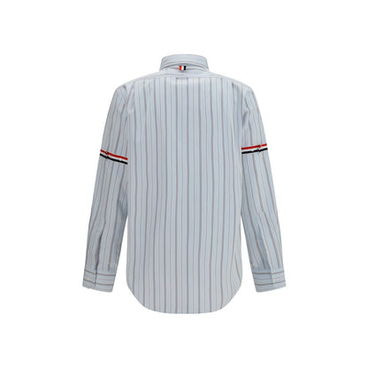 Dress Shirt by Thom Browne for men in cotton blue, signature & striped presents a discerning silhouette, showcasing a sophisticated button-down-collar neckline and for a truly discerning finish.
