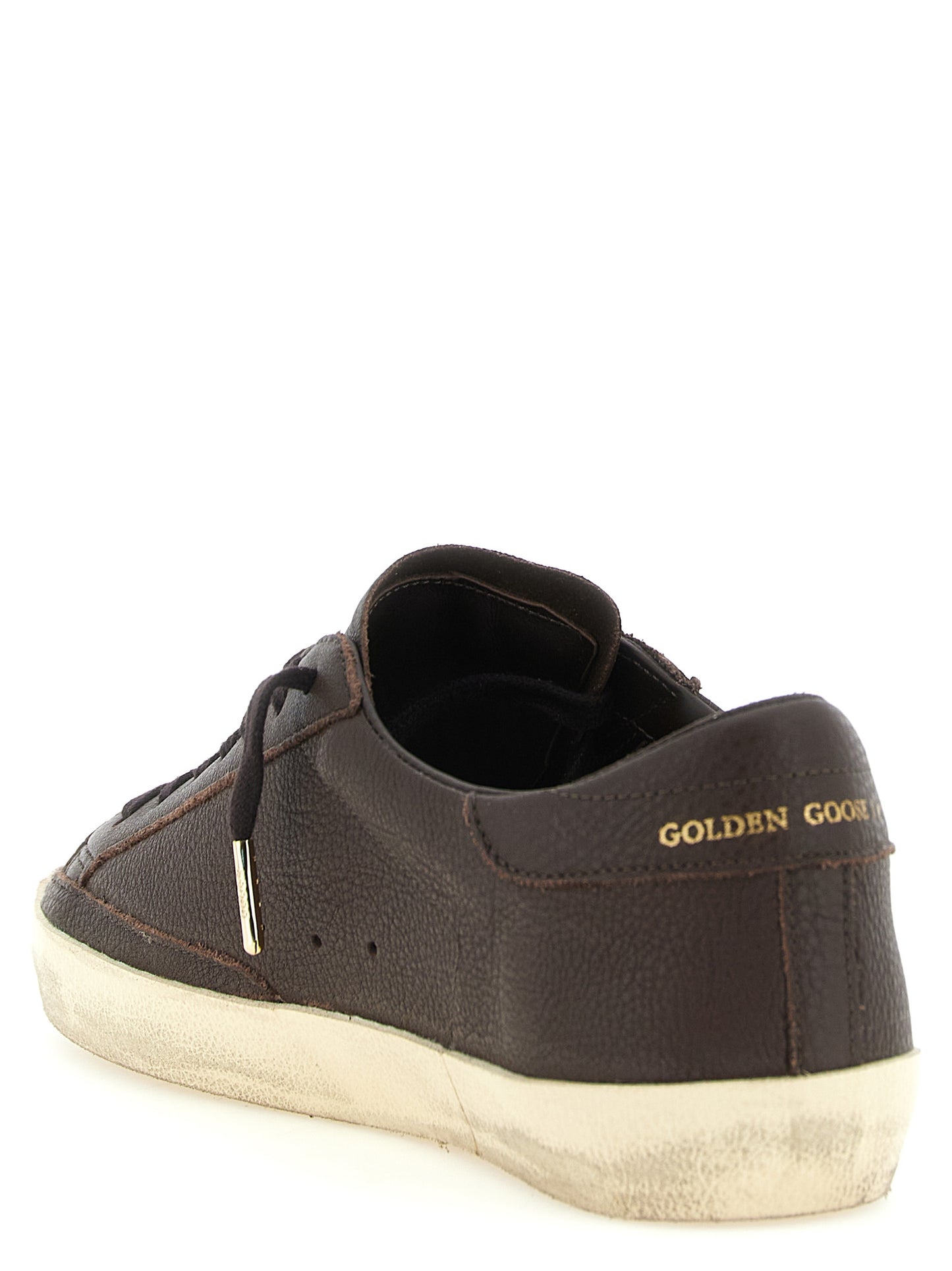 Sneakers by Golden Goose for men in cowhide leather brown, gold & signature presents a sumptuous silhouette, artfully capturing the essence of the Star Men's Low Top Cowhide Leather Sneakers with its sumptuous low-top style design.