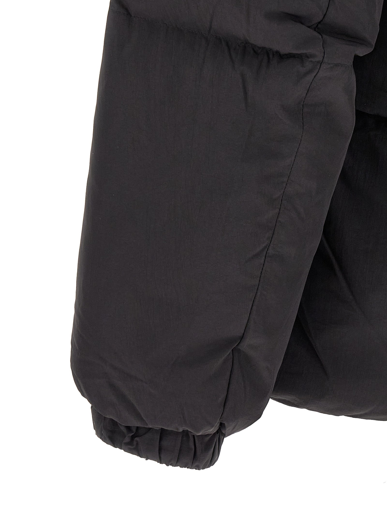 This Hooded Puffer Jacket by Diesel for men in polyamide black exhibits a edgy silhouette, meticulously detailed with functional hooded & insulated and a edgy hooded high-neck neckline for a edgy finish.