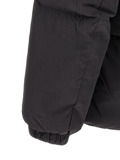 This Hooded Puffer Jacket by Diesel for men in polyamide black exhibits a edgy silhouette, meticulously detailed with functional hooded & insulated and a edgy hooded high-neck neckline for a edgy finish.
