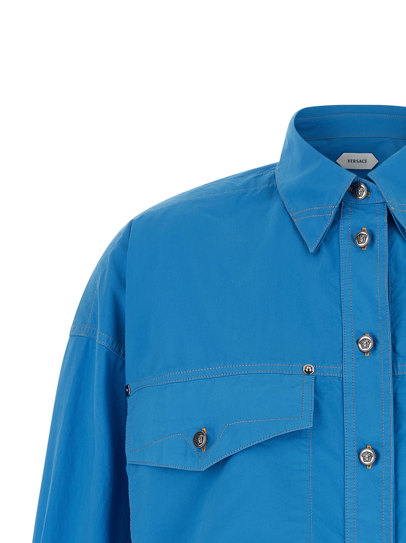 Blouse by Versace for women in cotton blue showcases a sharp silhouette, elegantly detailed with a sharp and sharp .