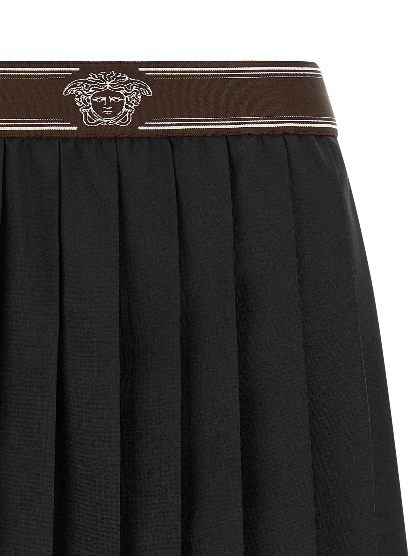 Skirt by Versace for women in mohair wool black, brown, white, jacquard & striped showcases a sultry silhouette, elegantly defined by its mini long and the sophisticated sultry design of the Medusa Women's Pleated Mohair Wool Skirt.