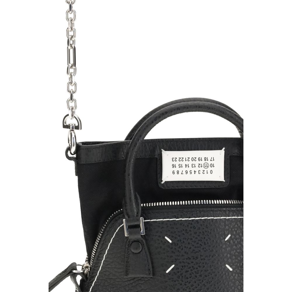 Shoulder Bag by Maison Margiela for women in bos taurus calf leather black, signature & monogram features an effortlessly chic silhouette with a secure zipper, ample internal-pockets, and versatile shoulder-strap, handle & adjustable-strap for effortlessly chic everyday luxury.