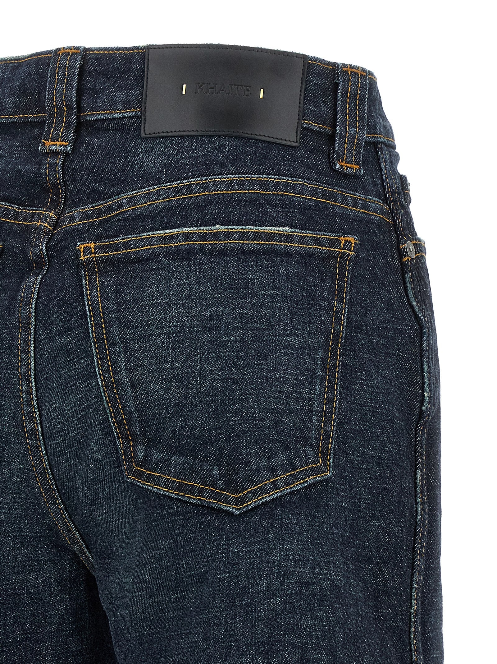 Jeans by Khaite for women in polyurethane leather & cotton denim blue presents a refined pantology silhouette, artfully defined by a refined pantology flared & wide, long, and a sophisticated high rise.