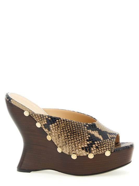 Wedge Mules Sandals by Magda Butrym for women in bos taurus calfskin python leather brown, gold, natural & print features an statuesque Women's Bos Taurus Calfskin Python Leather Wedge Mules Sandals silhouette with a refined wedge and elegant .