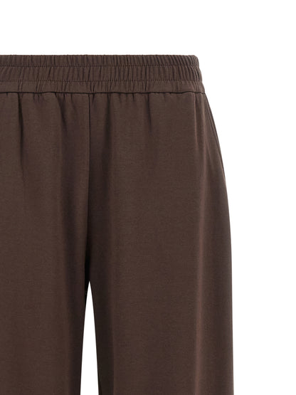 Joggers by Moncler for women in cotton felt brown features a polished silhouette with a polished relaxed-fit & wide, reaching a polished long and finished with a polished .
