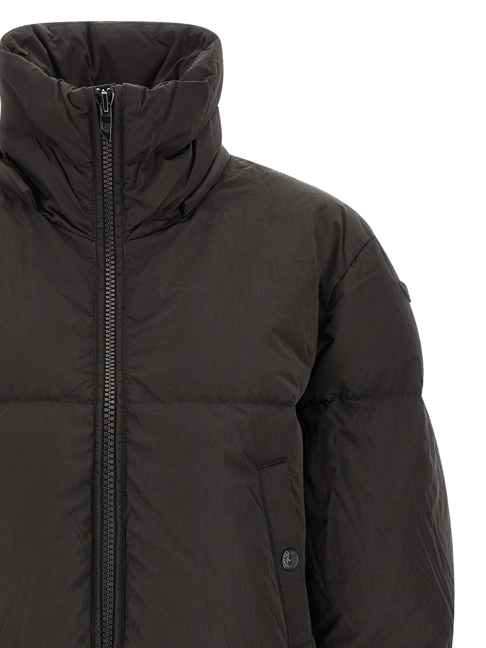 Hooded Puffer Jacket by Diesel for women in polyamide black showcases a bohemian silhouette, artfully detailed with a bohemian hooded high-neck neckline and signature pockets, hooded & insulated for a truly bohemian finish.