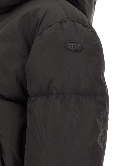 This Hooded Puffer Jacket by Diesel for women in polyamide black exhibits a edgy silhouette, meticulously detailed with functional pockets, hooded & insulated and a edgy for a edgy finish.