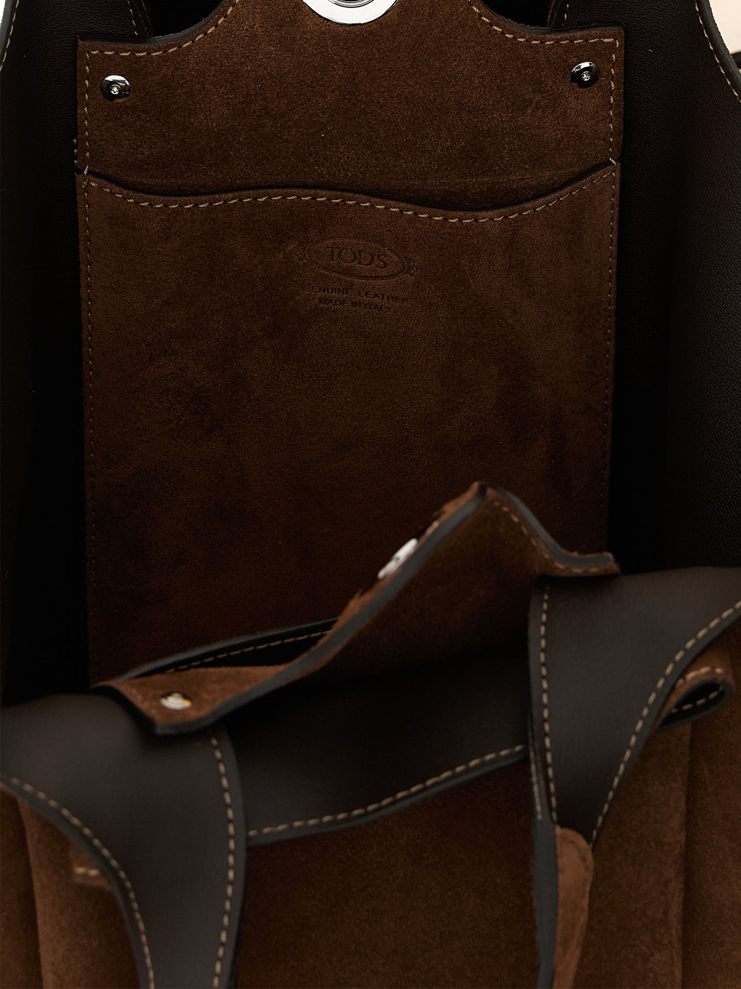 This Bucket Handbag by Tod's for women in calfskin leather and brown & silver presents a sculptural silhouette featuring a secure , ample , and versatile shoulder-strap, handle & adjustable-strap for a sculptural finish.