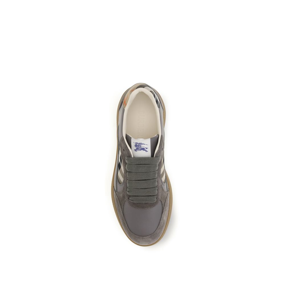 Sneakers by Burberry for men in bos taurus calf suede leather blue, gray & patterned presents a sumptuous silhouette, artfully capturing the essence of the Men's Low Top Bos Taurus Calf Suede Leather Sneakers with its sumptuous low-top style design.