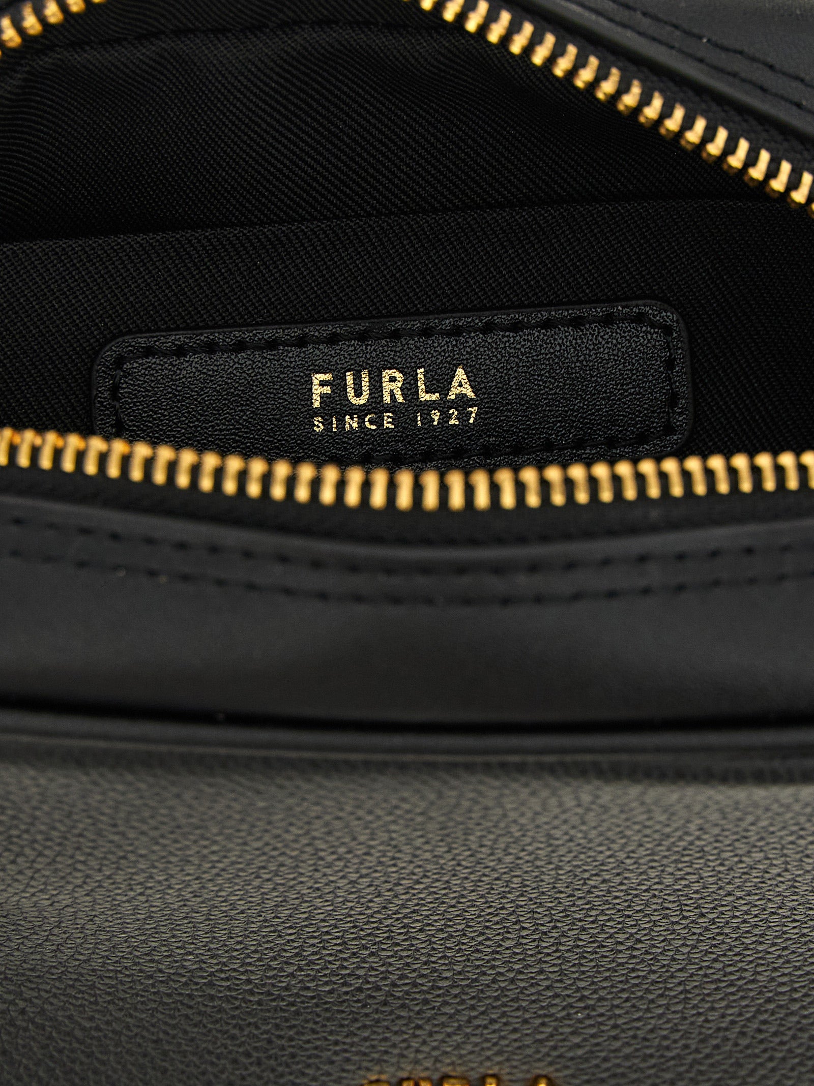Compact Handbag by Furla for women in bos taurus calf suede leather black & gold presents a ornamental silhouette, showcasing a secure zipper, ample , and versatile shoulder-strap, adjustable-strap & handle for a ornamental finish.