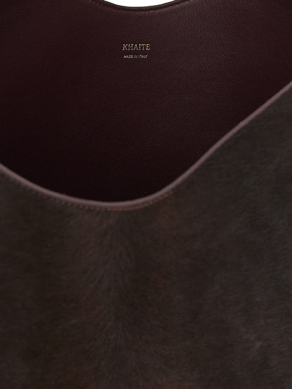Small Shopper Tote Bag by Khaite for women in calfskin leather bordeaux & gold features an jet-setting Lotus Calfskin Leather Small Shopper Tote Bag design with a secure , jet-setting , and versatile handle for a jet-setting look.