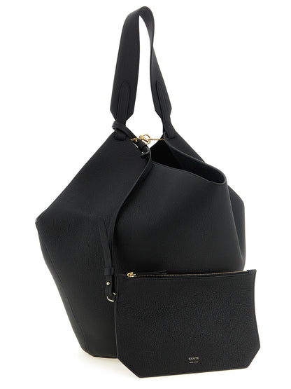 Tote Clutch Bag by Khaite for women in bos taurus calfskin leather black & gold features an jet-set-ready silhouette, showcasing the Lotus Bos Taurus Calfskin Leather Tote Clutch Bag design with a secure , ample , and versatile handle.