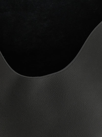 Tote Clutch Bag by Khaite for women in bos taurus calfskin leather black & gold features a jet-set sophisticated Lotus Bos Taurus Calfskin Leather Tote Clutch Bag design with a secure , ample , and versatile handle for a jet-set sophisticated finish.