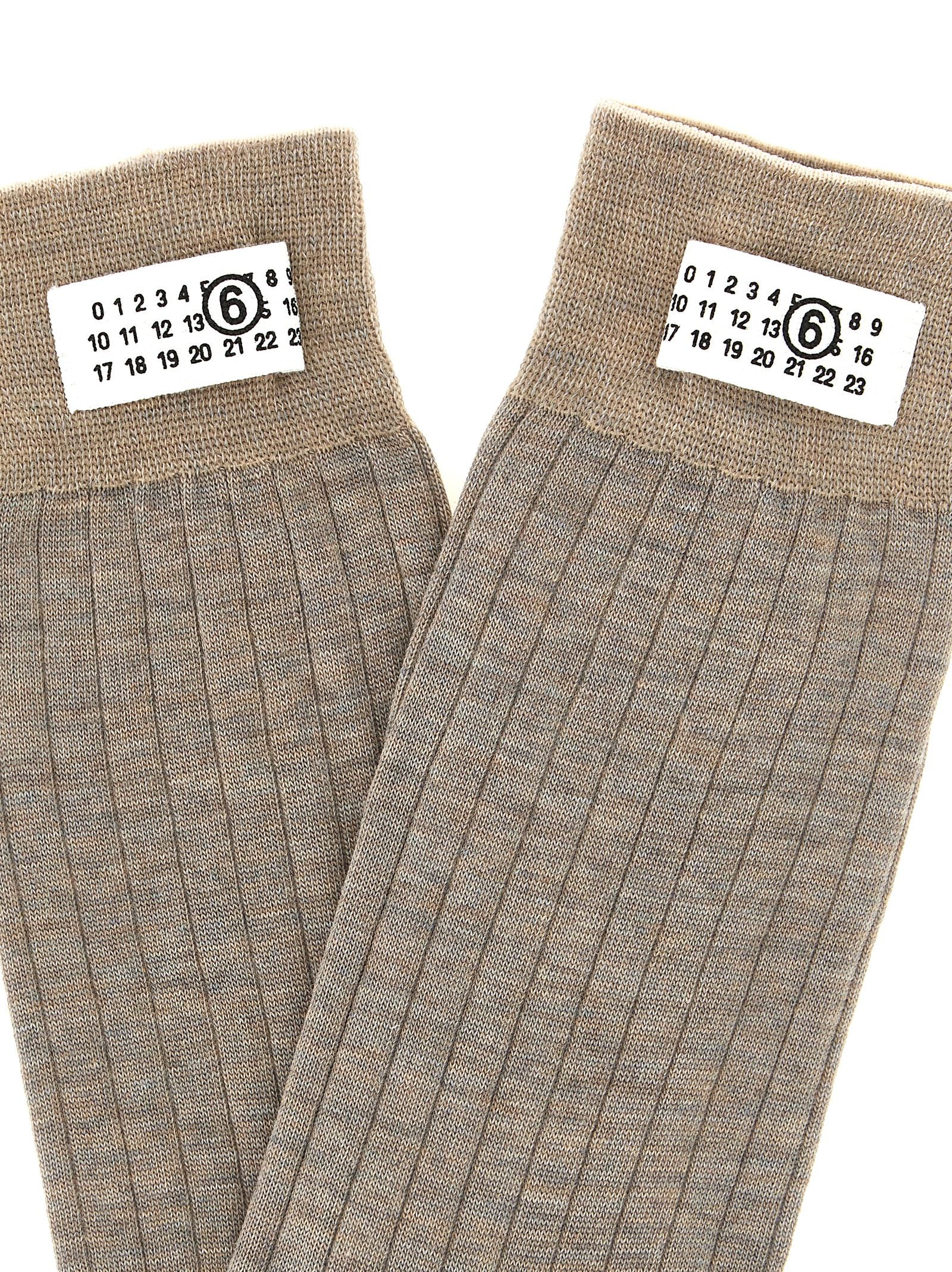 These Socks by MM6 Maison Margiela for women in polyamide wool beige & signature present a utilitarian silhouette from the Women's Polyamide Wool Socks collection, offering a utilitarian fit and refined aesthetic.