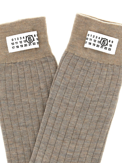 These Socks by MM6 Maison Margiela for women in polyamide wool beige & signature present a utilitarian silhouette from the Women's Polyamide Wool Socks collection, offering a utilitarian fit and refined aesthetic.