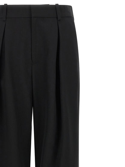 Trousers by MM6 Maison Margiela for women in polyester & virgin wool black, white & jacquard presents a perennial silhouette, meticulously tailored with a wide cut, long finish, and an elegant high rise.