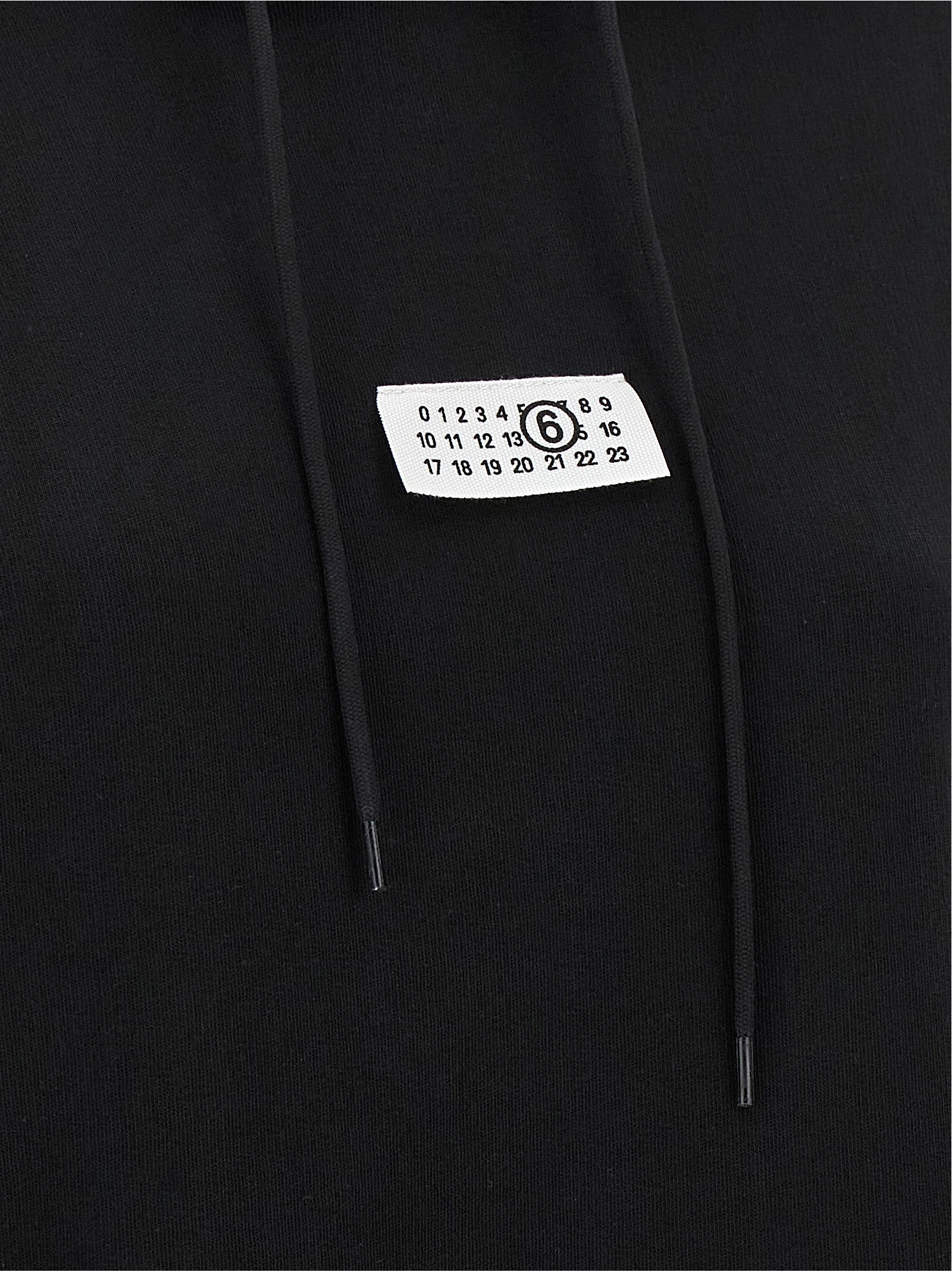 Sweatshirt Hoodie by MM6 Maison Margiela for women in cotton black, white & signature features an avant-garde silhouette, showcasing a sophisticated and detail for a truly avant-garde finish.